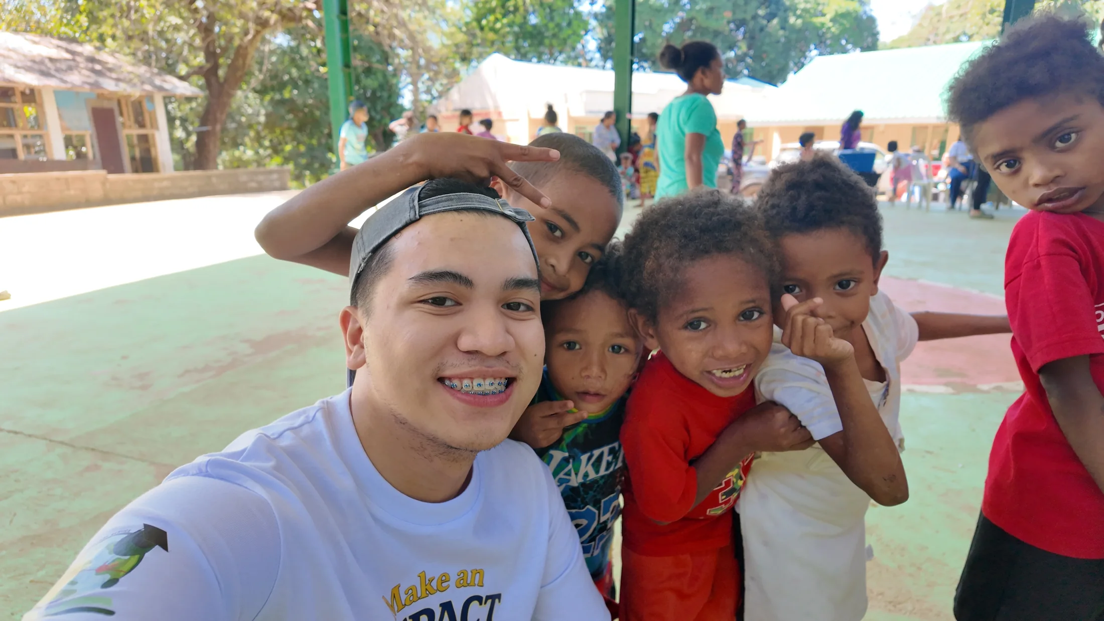 An LFI volunteer and children sharing a joyful moment during a community visit