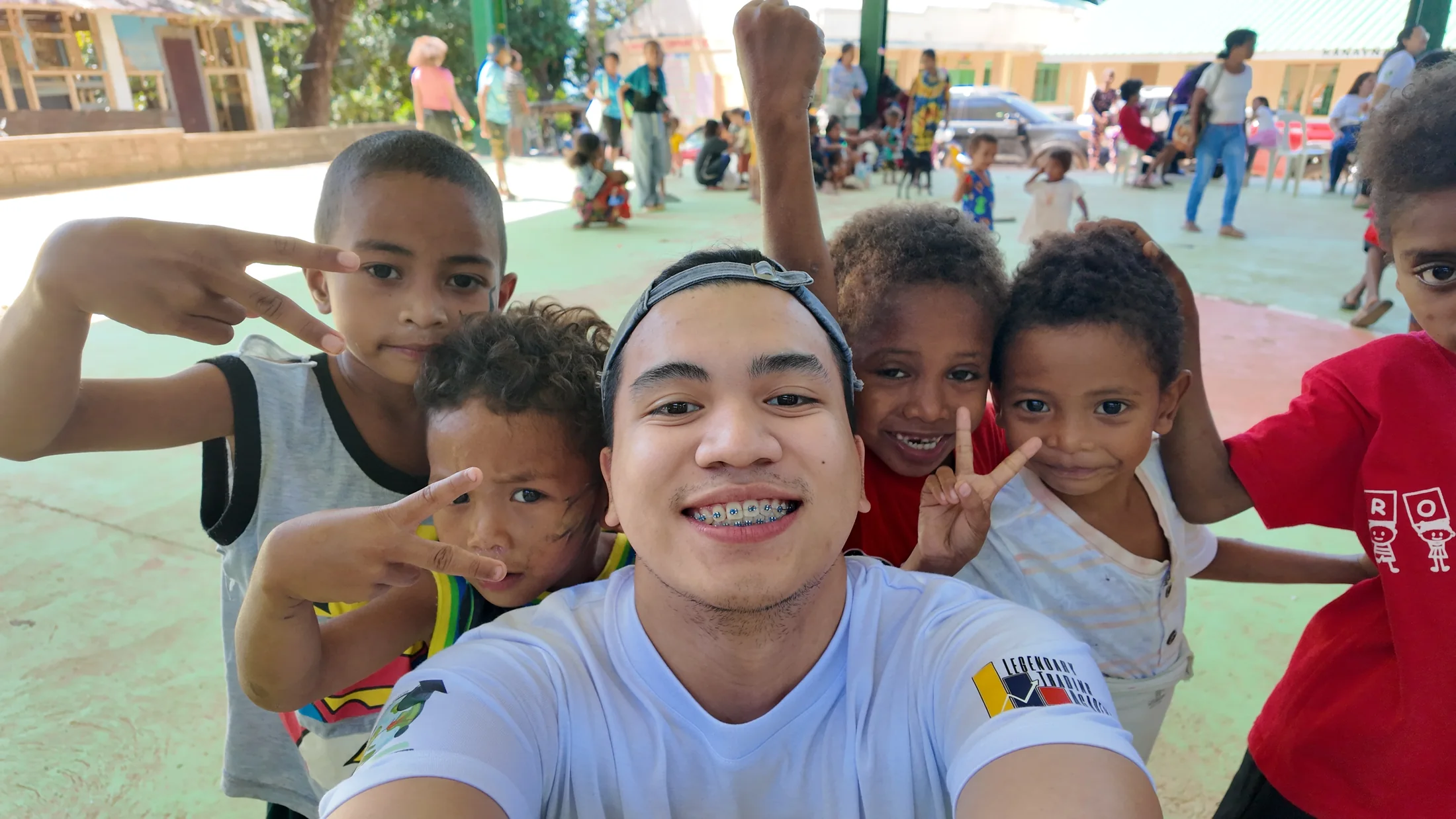 An LFI volunteer with children during an outreach visit
