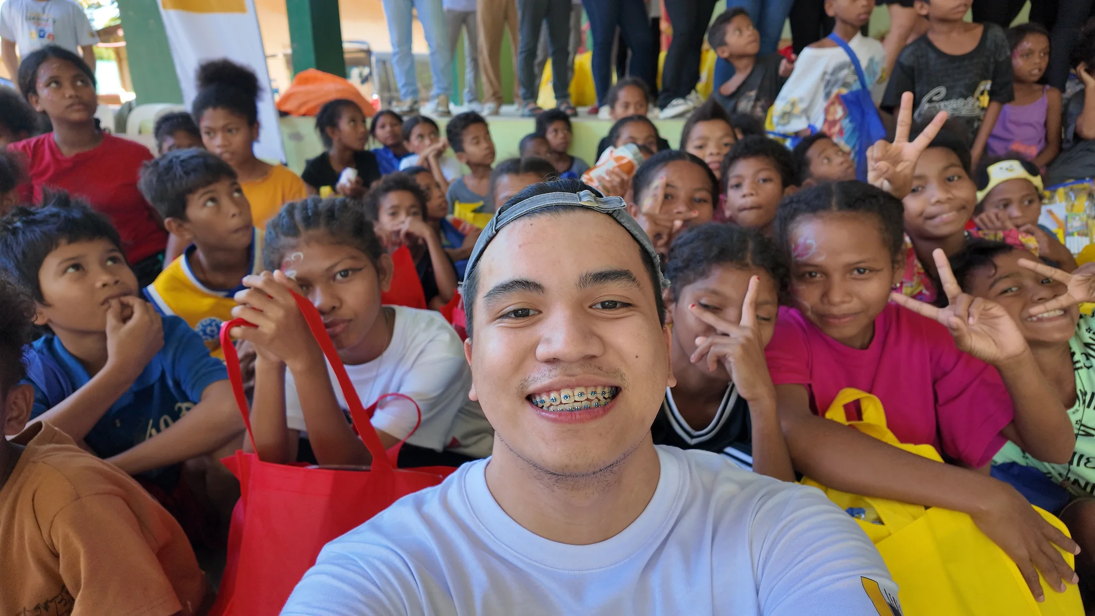 Children and an LFI volunteer gathered during the outreach