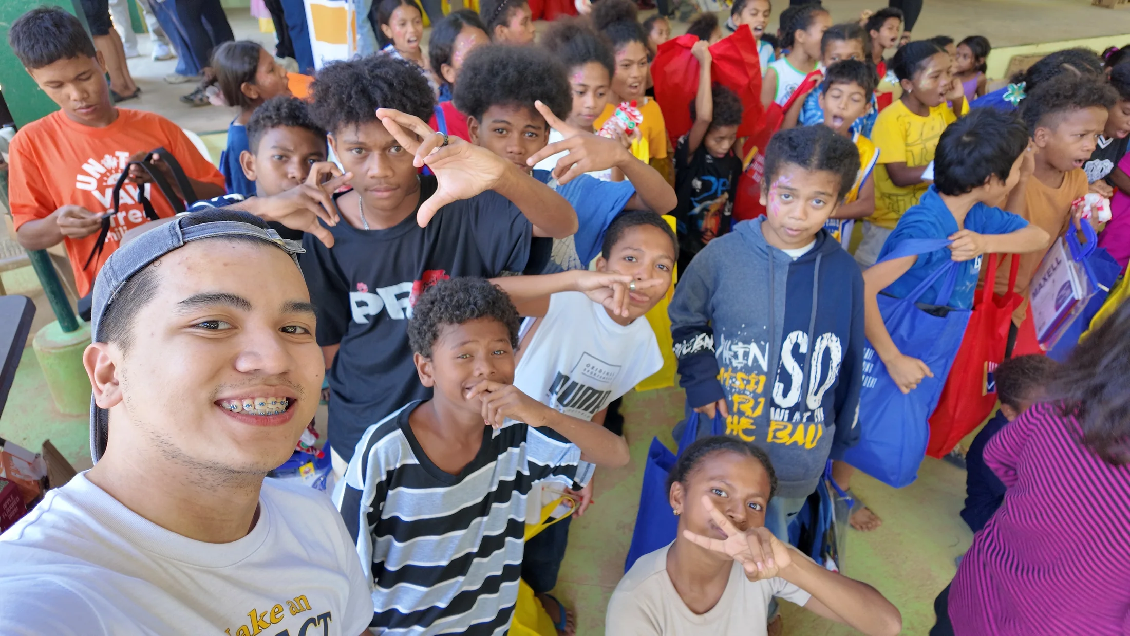 Children and an LFI volunteer during a community outreach activity